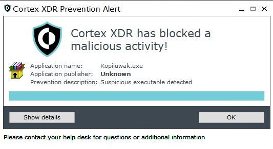 画像 12 は Cortex XDR Prevention Alert ウィンドウのスクリーンショットです。Cortex XDR has blocked a malicious activity!Application name: Kopiluwak.exeApplication publisher: UnknownPrevention description: Suspicious executable detected[Show (詳細を表示)] と [OK] の 2 つのボタンがあります。